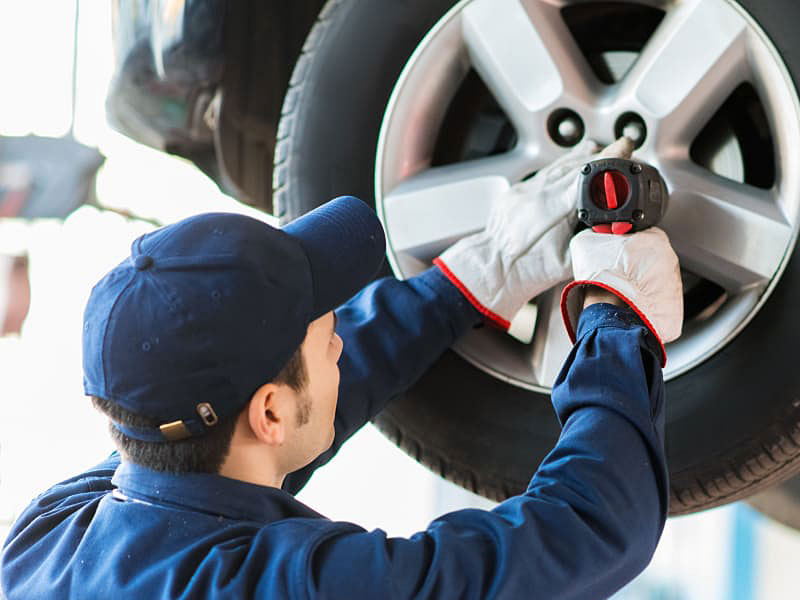 Mechanic checking tires and rotating wheels -Justfix Automotive 120 Munro Ave Sunshine North 3020
